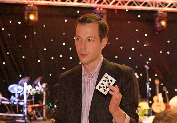 man holding card club of nine